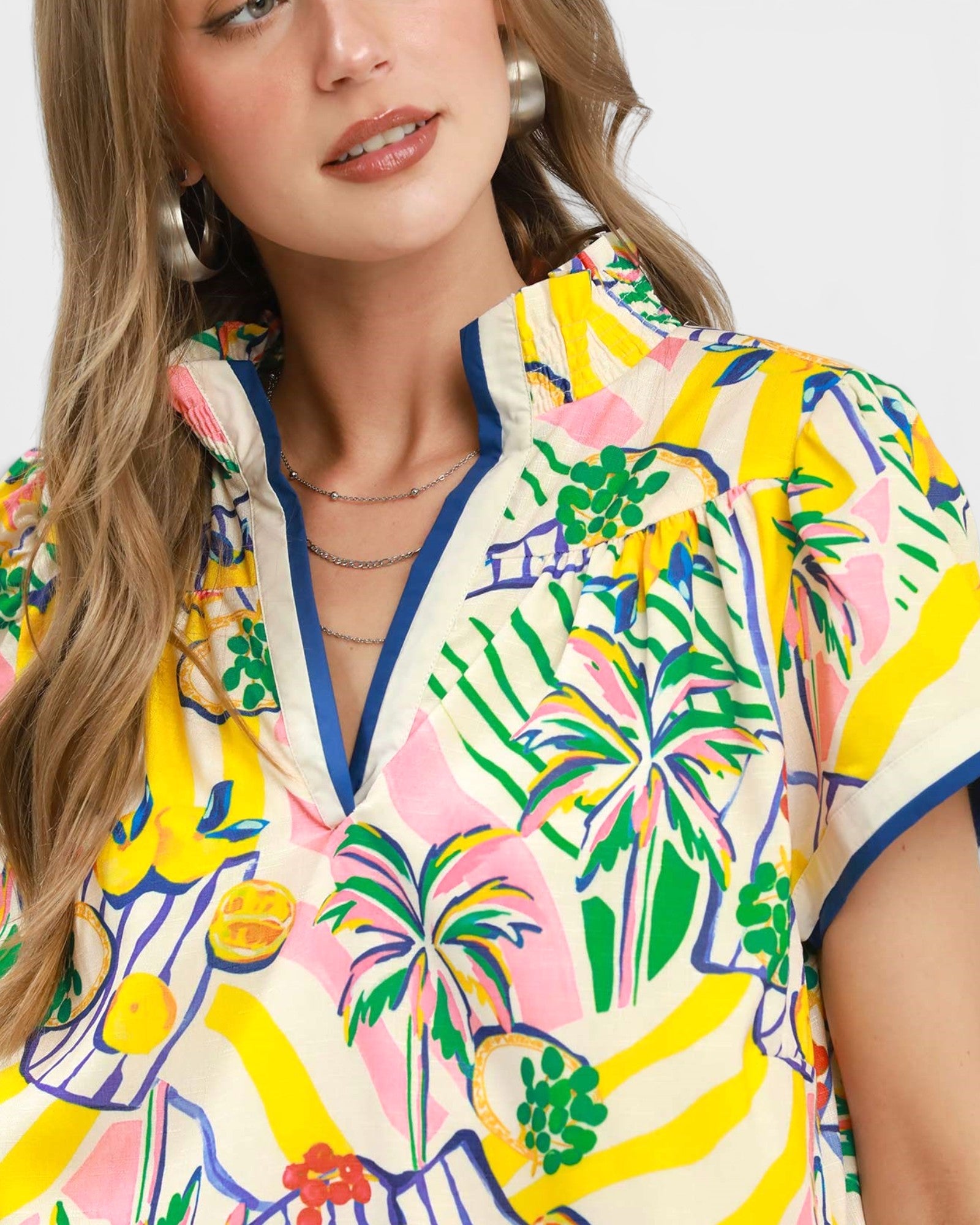 Woman wearing a colorful floral dress with a white background