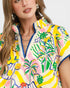 Woman wearing a colorful floral dress with a white background
