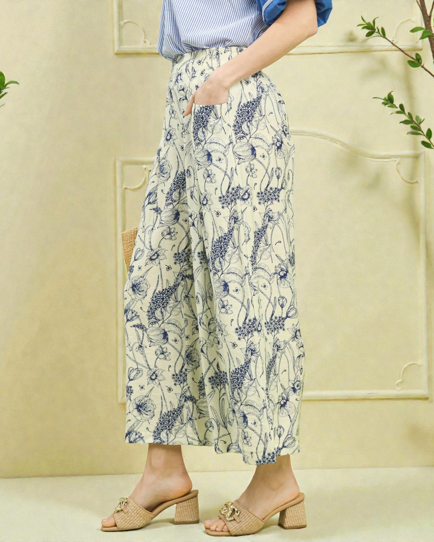 Person wearing floral pants with a light background