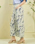Person wearing floral pants with a light background