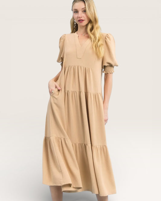 Woman wearing a beige dress on a white background