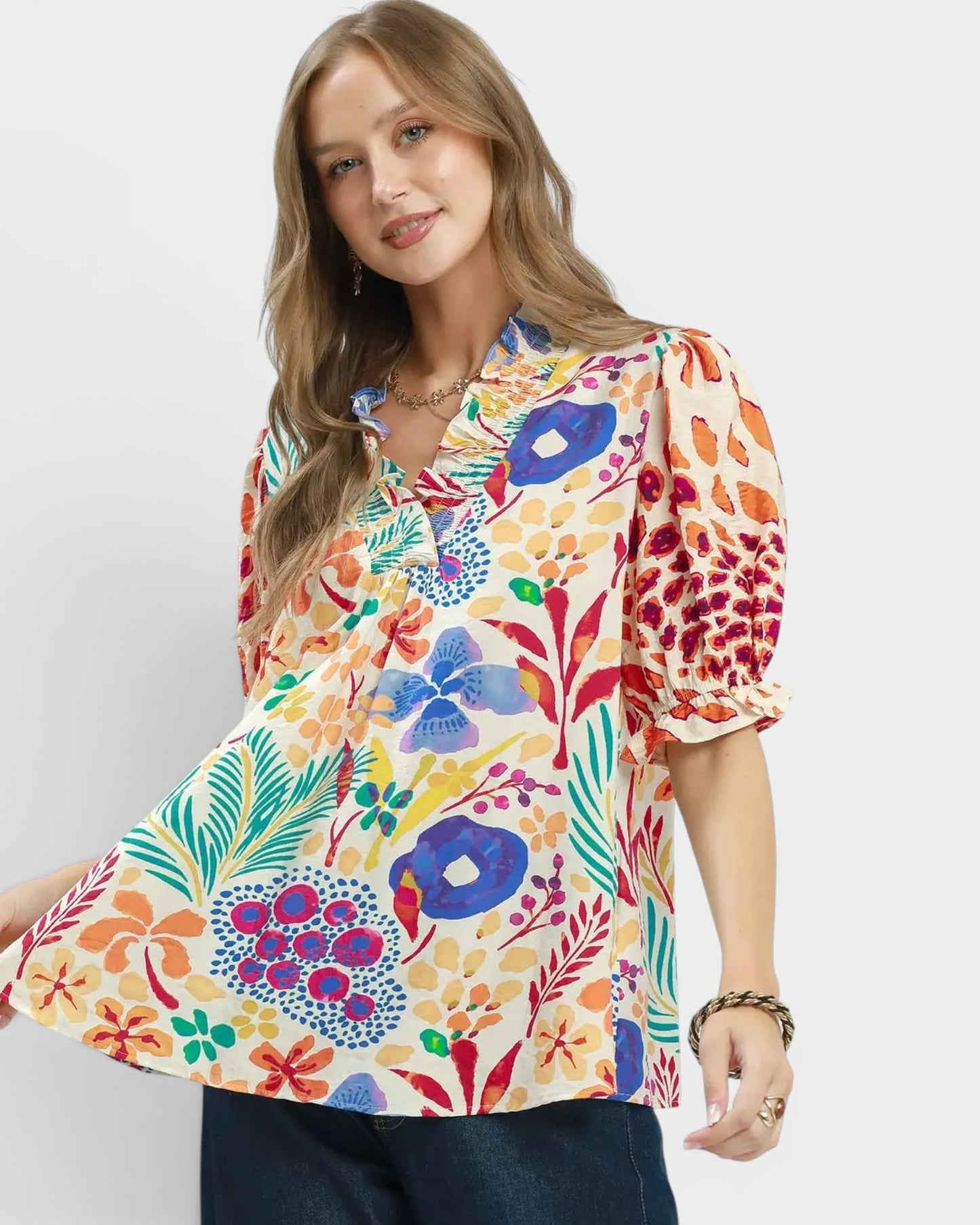 Woman wearing a colorful floral blouse on a white background
