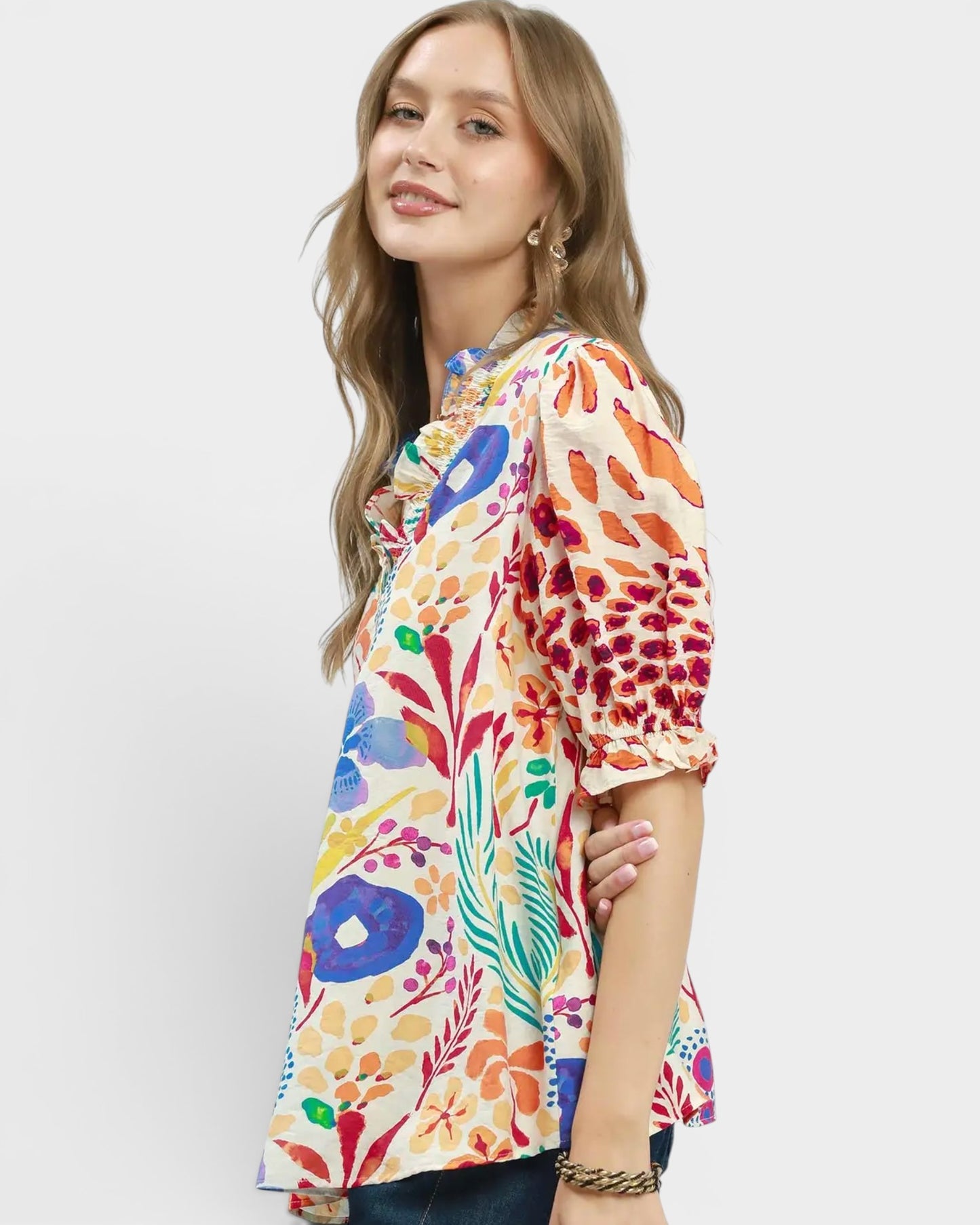 Woman wearing a colorful floral blouse on a white background