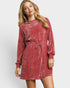 Woman wearing a red velvet dress on a white background