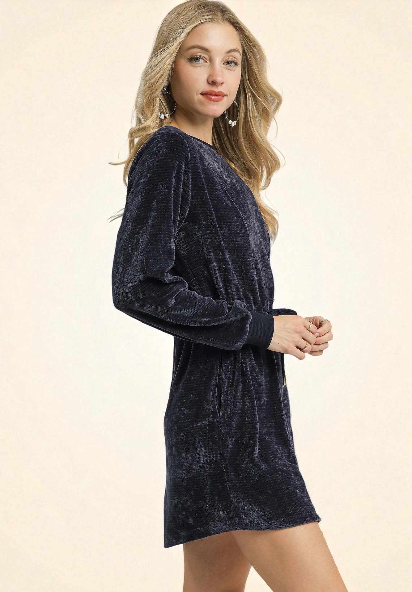 Woman wearing a navy blue dress on a beige background