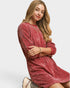 Woman wearing a red velvet dress on a white background