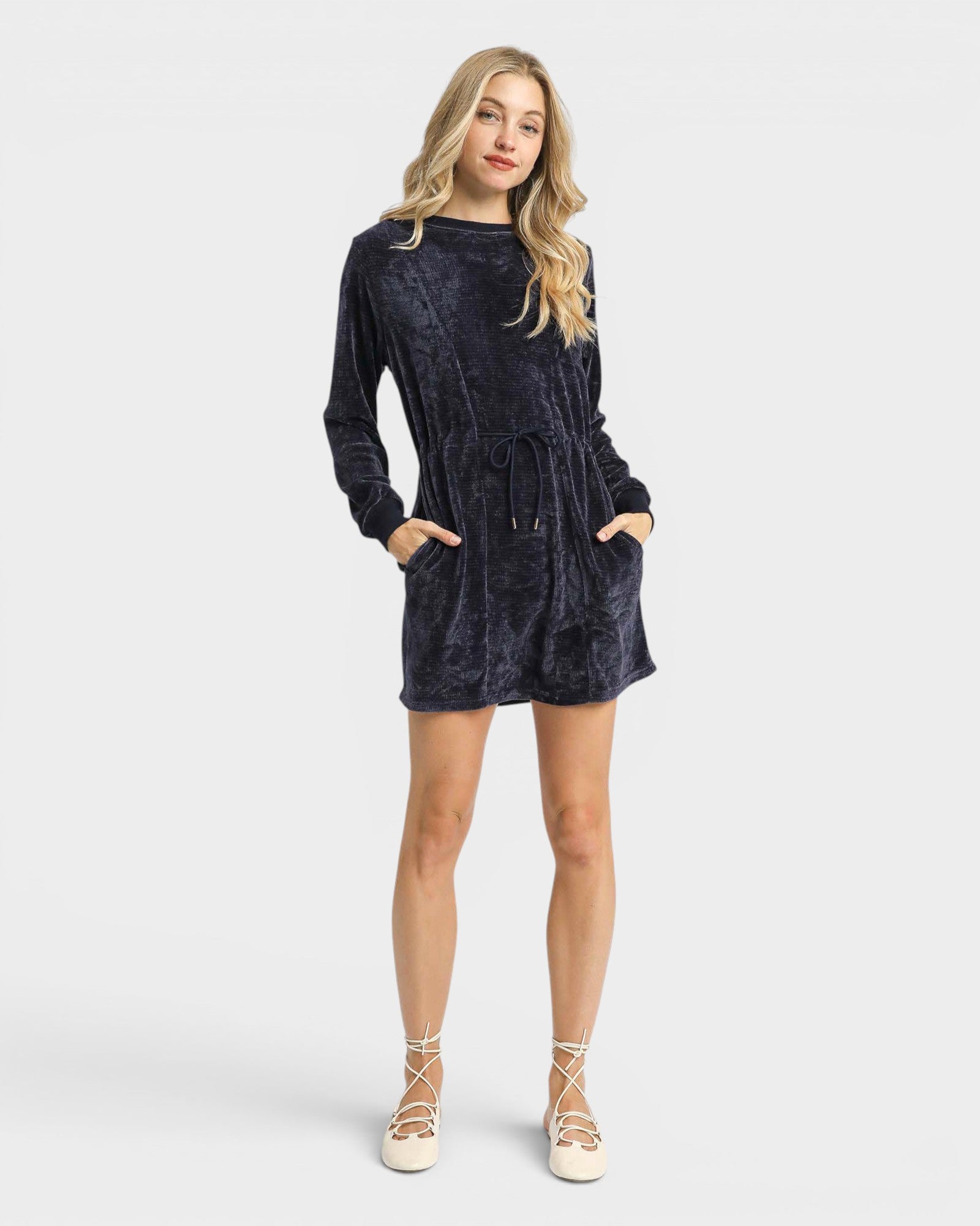 Woman wearing a dark blue dress on a white background