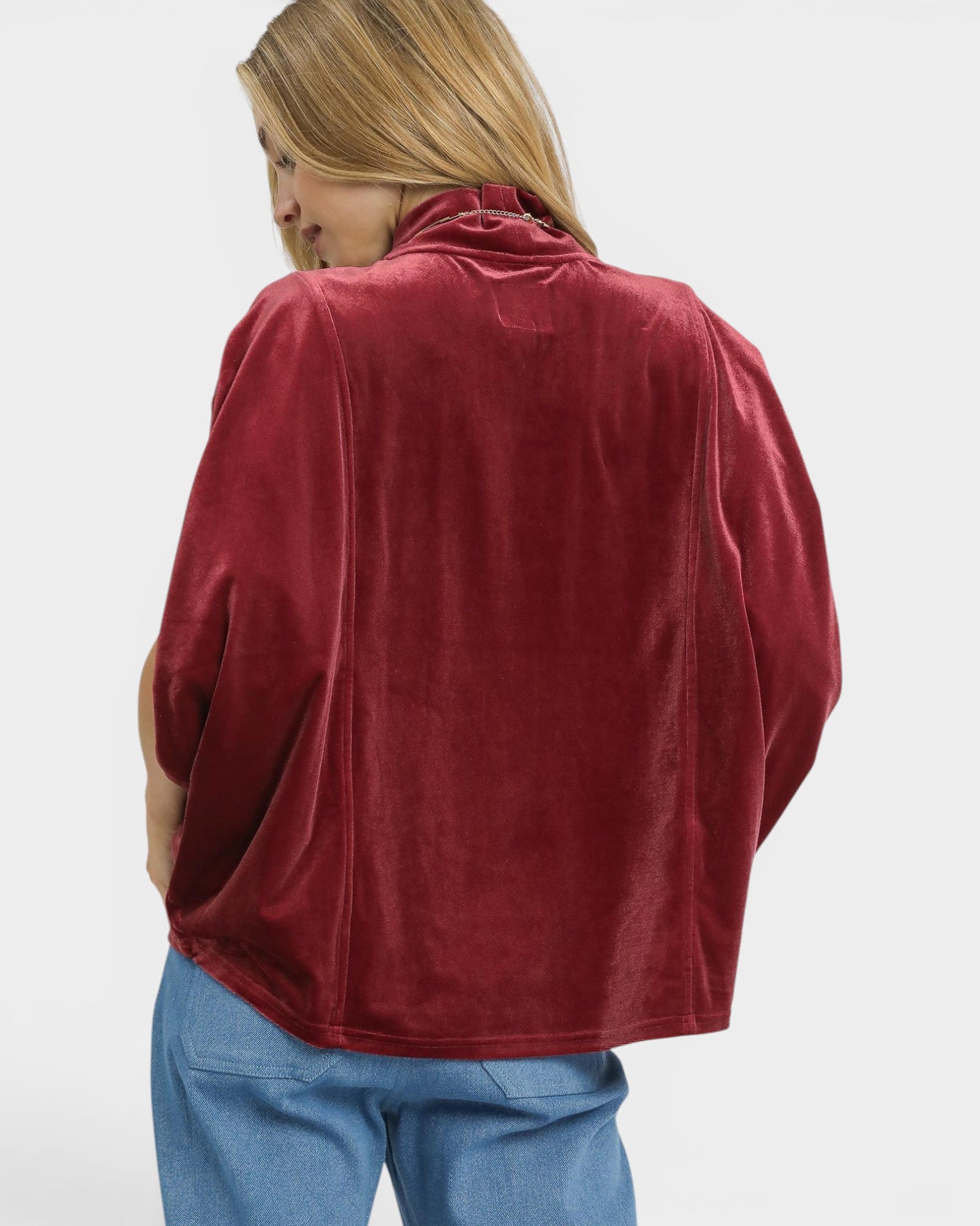 Person wearing a red fleece jacket on a white background