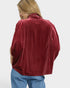 Person wearing a red fleece jacket on a white background