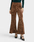Brown patterned pants worn by a person on a white background