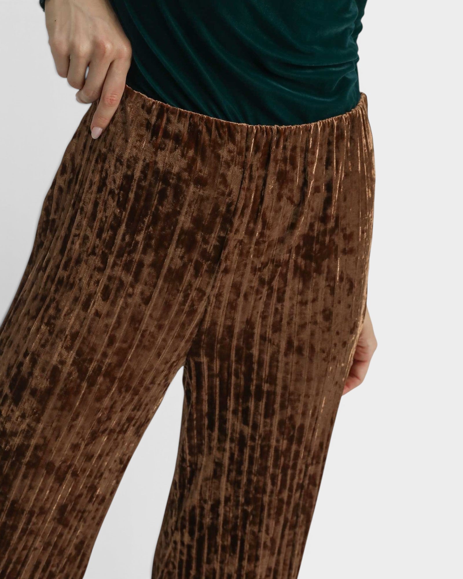 Brown patterned pants worn by a person on a light gray background