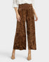 Brown crushed velvet wide-leg pants worn by a person on a white background