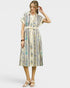 Woman wearing a patterned dress on a white background