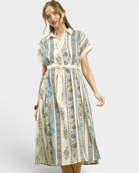 Woman wearing a patterned dress on a white background