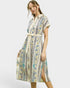 Woman wearing a patterned dress on a white background