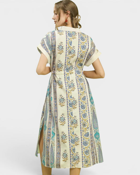 Woman wearing a patterned dress with a white background