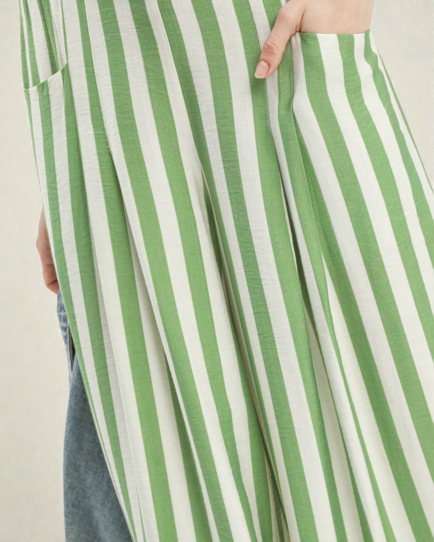 Green and white striped pants with a neutral background