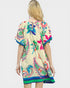 Woman wearing a colorful dress with floral patterns on a white background