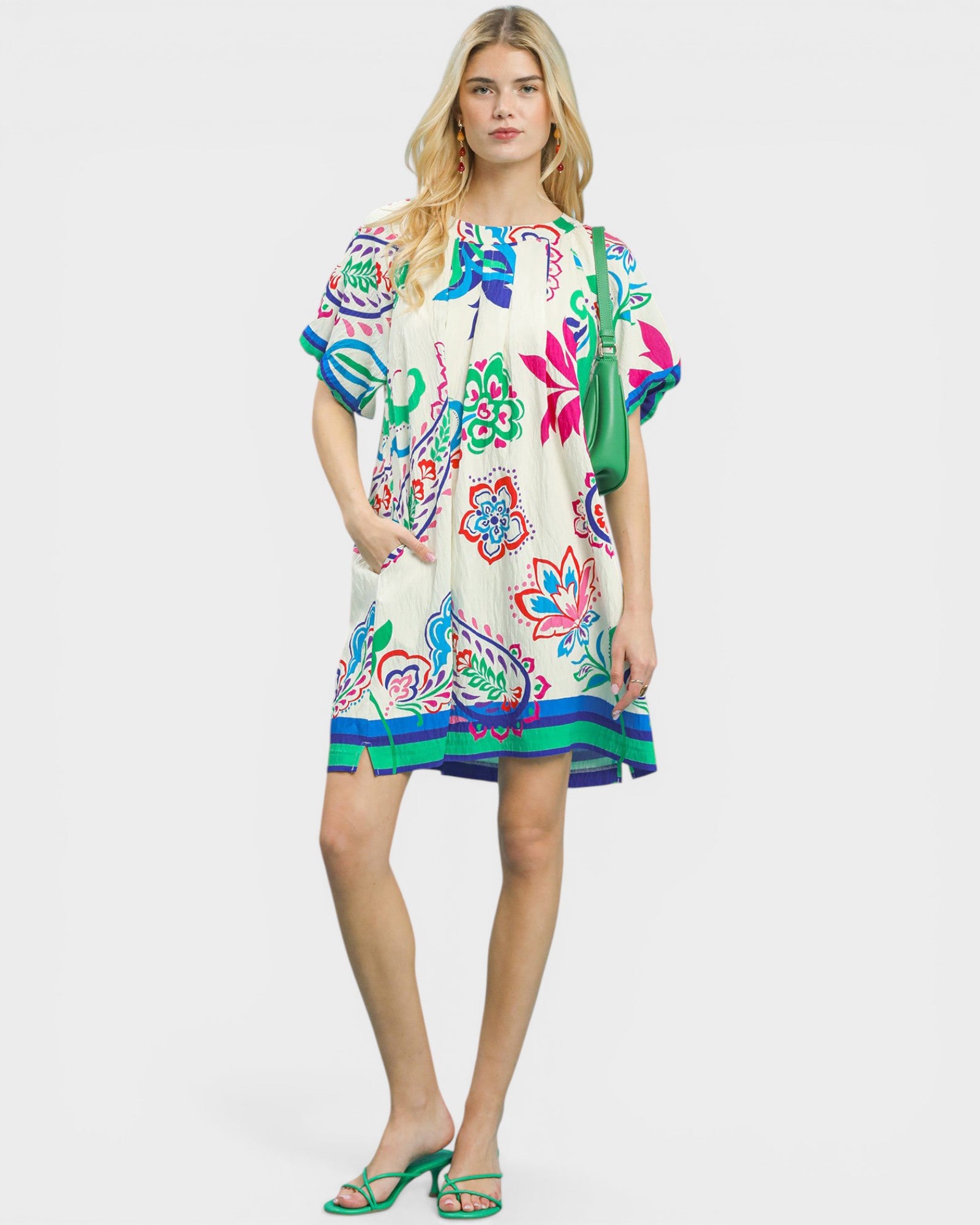 Woman wearing a colorful floral dress on a white background