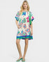 Woman wearing a colorful floral dress on a white background