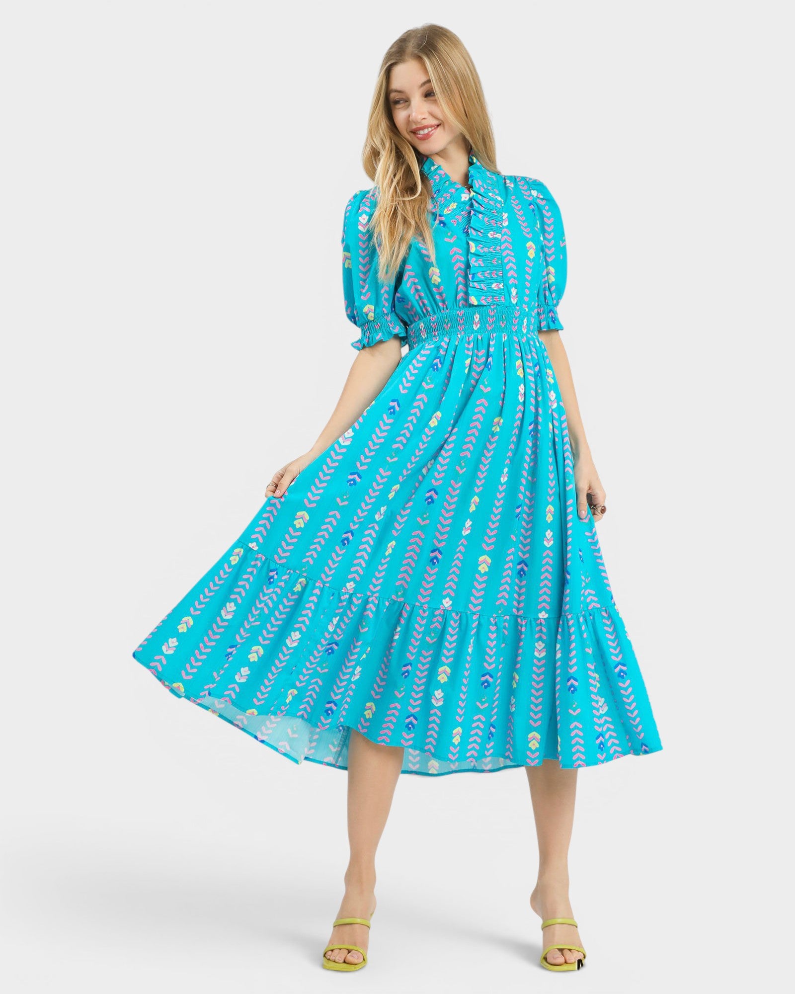 Woman wearing a blue patterned dress on a white background