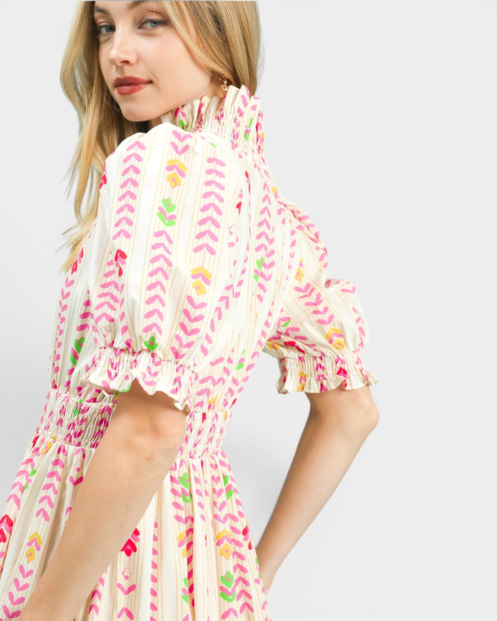 Woman wearing a colorful dress with a white background