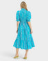 Woman wearing a blue patterned dress on a white background