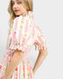 Woman wearing a colorful dress with a white background