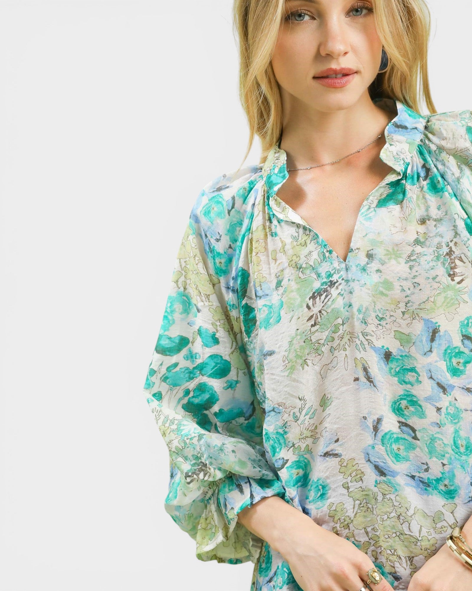 Woman wearing a floral blouse with a white background