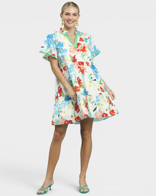 Woman wearing a colorful floral dress on a white background