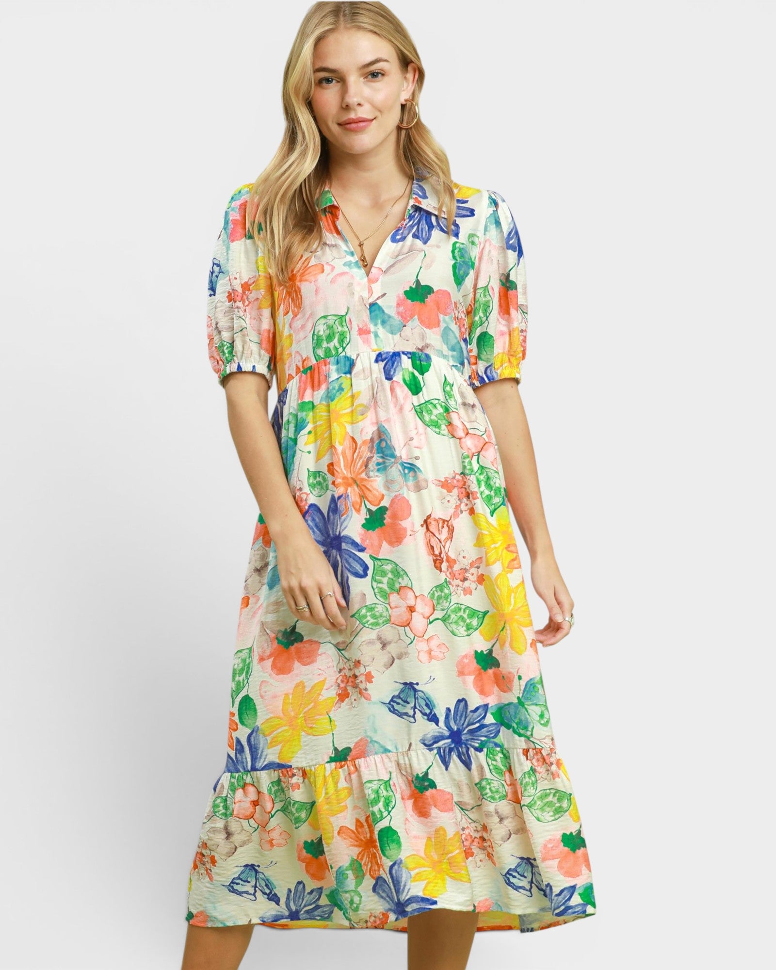 Woman wearing a colorful floral dress on a white background