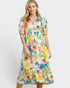 Woman wearing a colorful floral dress on a white background
