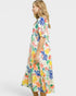 Woman wearing a colorful floral dress on a white background