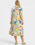 Woman wearing a colorful floral dress on a white background