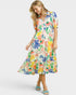Woman wearing a colorful floral dress on a white background