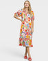 Woman wearing a colorful floral dress on a white background