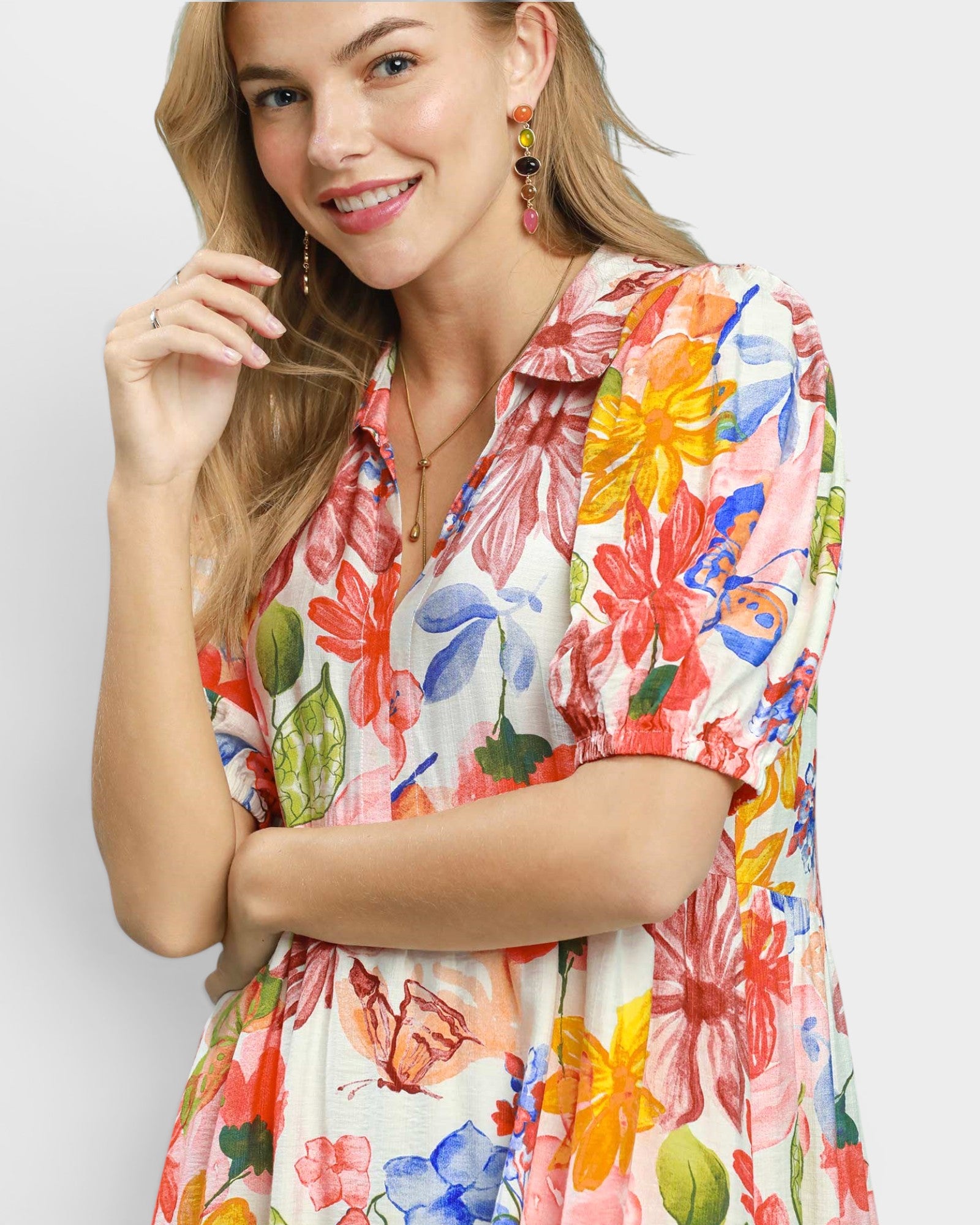 Woman wearing a colorful floral dress on a white background