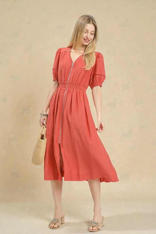 Woman wearing a red dress against a beige background