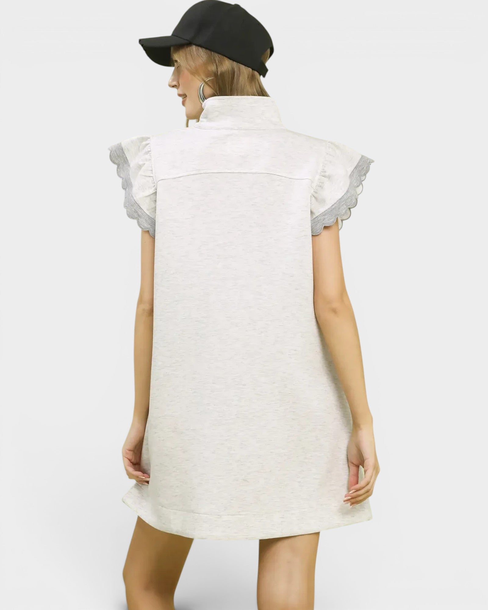 White dress with ruffled sleeves worn by a person on a white background