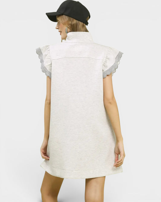 White dress with ruffled sleeves worn by a person on a white background