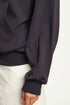 Dark black hoodie with white pants on a plain background