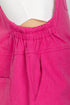 Close-up of a bright pink denim dress with a tie waist.
