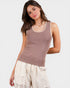 Woman wearing a brown tank top with lace trim on a white background