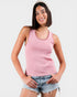 Woman wearing a pink sleeveless top with a white background