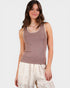 Woman wearing a brown sleeveless top with lace trim on a white background