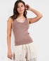 Woman wearing a brown sleeveless top with lace trim on a white background