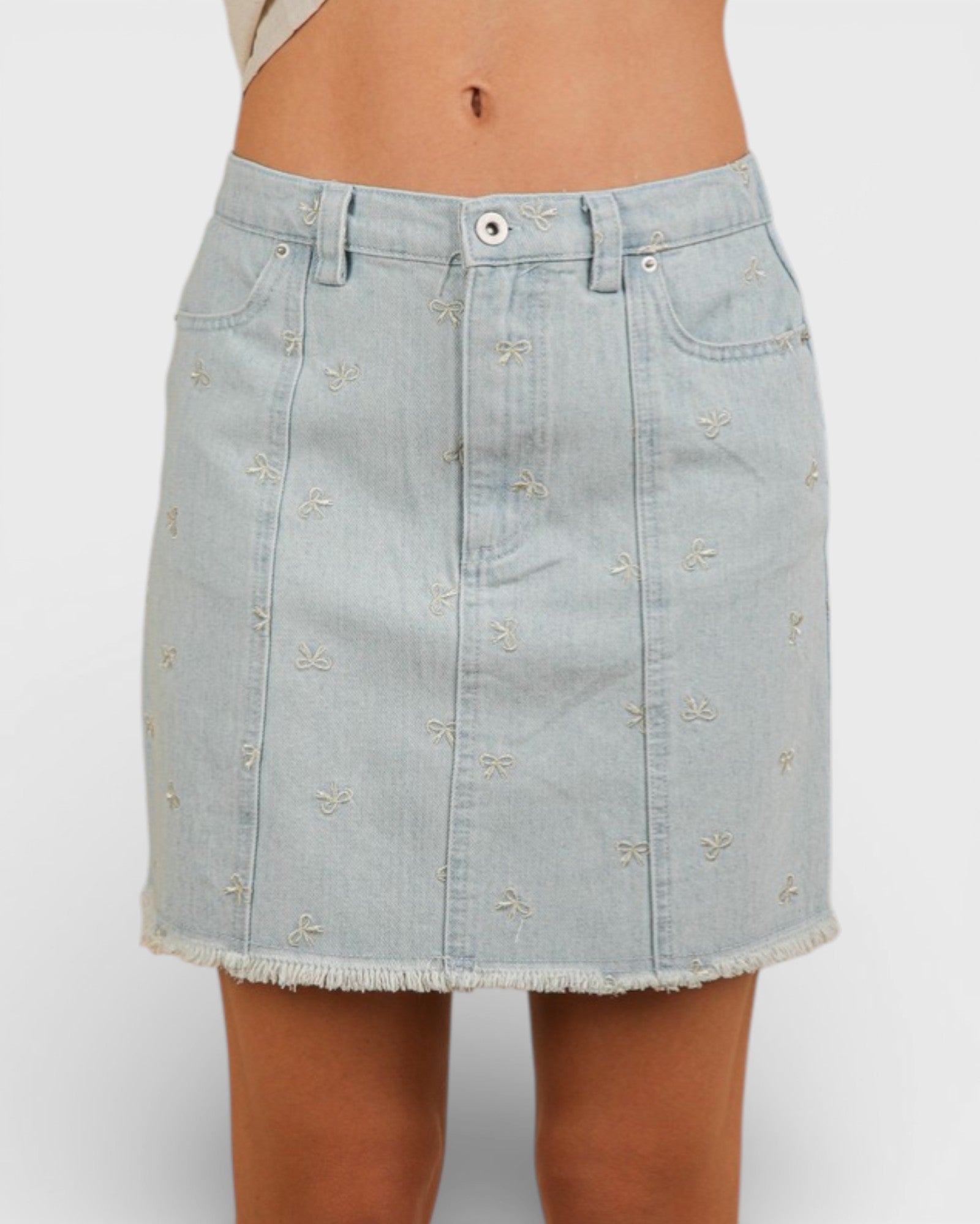 Light blue denim skirt with subtle pattern on a white background