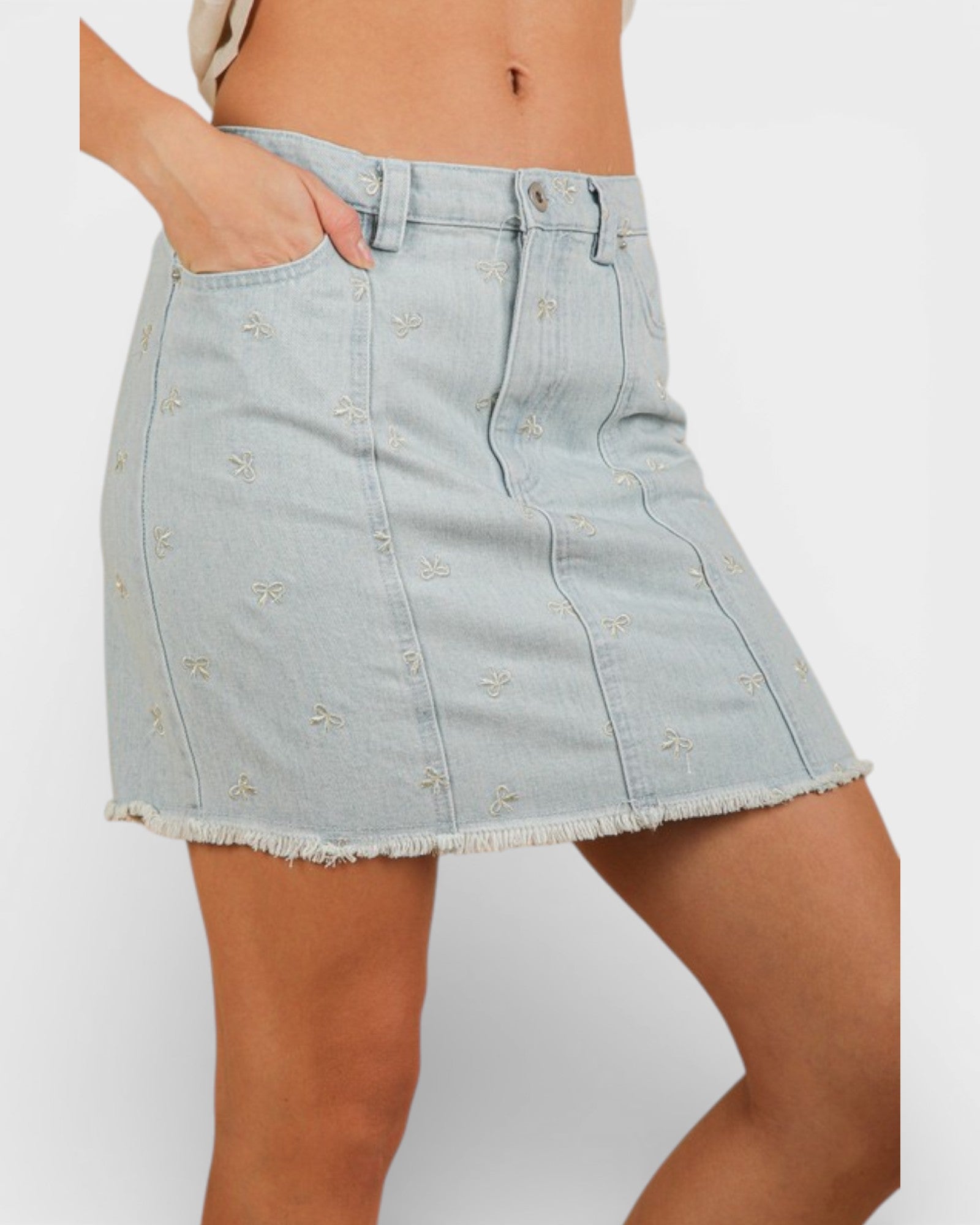 Light blue denim skirt worn by a person on a white background