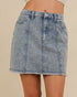 Denim skirt with floral embroidery on a beige background