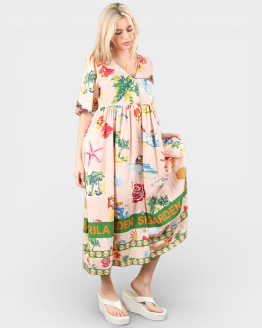 Woman wearing a colorful dress with floral and nature-themed print on a white background